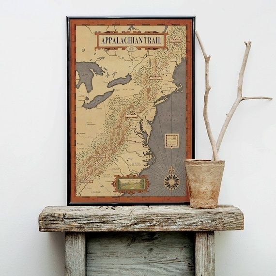 Framed Appalachian Trail map beside a rustic compass-like branch display